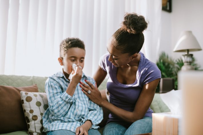 Mother Comforts Sick Child With Cold
