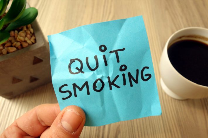Quit smoking – motivational reminder handwritten on sticky note